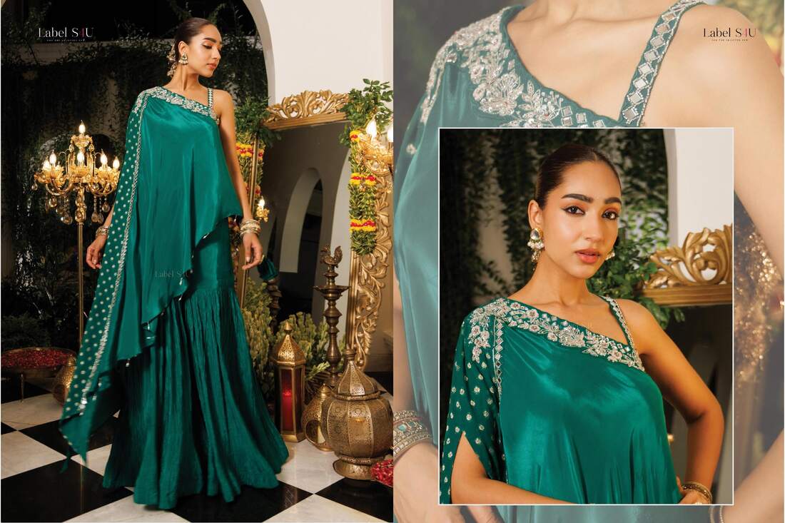 Teal one-shoulder cape top with a crushed sharara